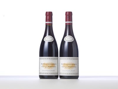 two bottles of red wine sitting on top of a table