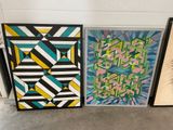 three paintings of different shapes and sizes on a wall next to a potted plant
