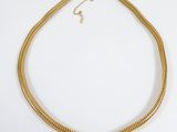 an image of a gold necklace on a white background
