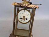 a small clock with a bird on top of it