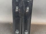 two black books sitting on top of a table next to each other