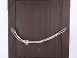 an old wooden picture frame with a rope wrapped around it