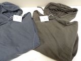 two men ' s hoodies are sitting on a table with tags on them
