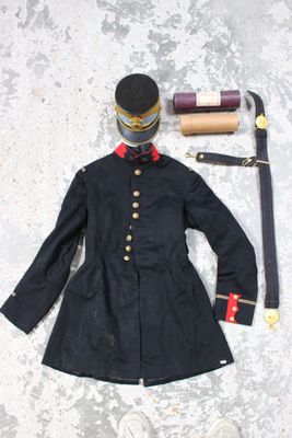 a black coat and a pair of white shoes on the ground