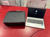 laptop and printer sitting on a red table in a store