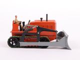 a toy tractor with a man sitting on top of it