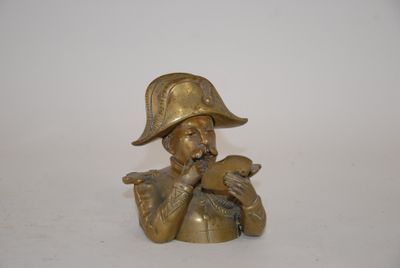 brass figurine of a man in a hat and holding a bird