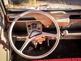 a steering wheel and dashboard of a car with a red seat