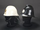 pair of white and black helmets sitting on top of a black table