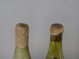 two wine bottles that are sitting next to each other