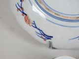 a blue and white plate with a flower design on it