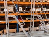 a man that is standing in front of a rack with boxes