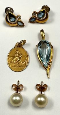 three pairs of earrings and a coin are shown on a white surface