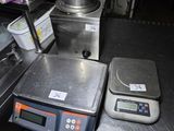 a picture of a kitchen with a scale and a kettle
