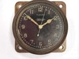 a clock that is sitting on the wall next to a wall clock