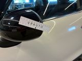 a sticker on the side mirror of a white car