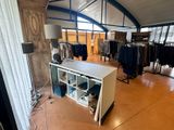 an image of a clothing store with a lot of clothes on display