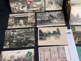 several old postcards of different types and sizes are on a table
