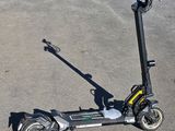 a scooter that is sitting on the ground in the parking lot