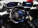 the interior of a car with a steering wheel, dashboard, and display screen