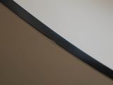 a close up view of a curved mirror on a wall