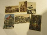 several old postcards of buildings and a clock on a table