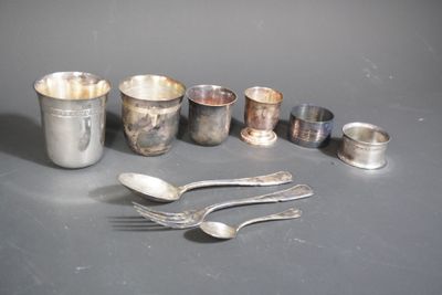 a lot of silver spoons and cups on the table