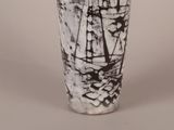 a black and white vase with a sailboat on it