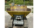 an image of a yellow dump truck parked in a gravel lot