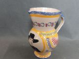 a small vase that has a picture of a man on it