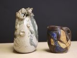 two vases sitting next to each other on a table