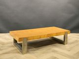 a wooden coffee table sitting on top of a wooden floor