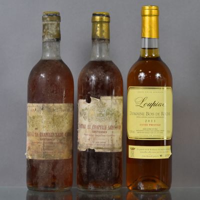 three bottles of wine sitting on a table next to each other