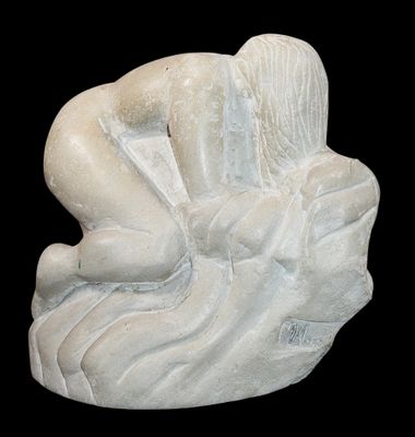 a statue of a woman sitting on a rock