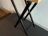 a wooden tray with a laptop on it sitting on a stand