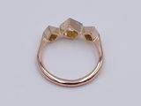 a close up of a gold ring on a white surface