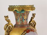 a gold vase with a blue and red design on it