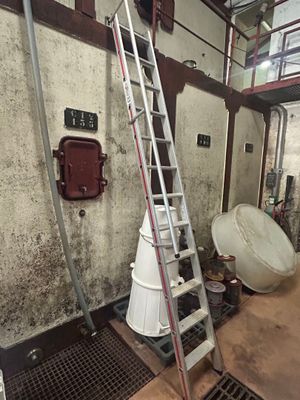 a ladder that is leaning against a wall in a room
