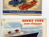two boxes of dinky toys are sitting on a white surface