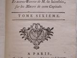 an old book with a picture of a coat of arms on top of it