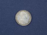 a close up of a coin on a blue cloth
