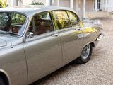 a silver car that is parked in front of a house