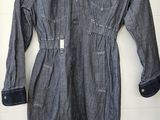 an image of a denim jumpsuit hanging on a wall