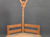 a wooden bench with a lamp on top of it