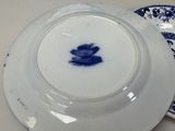 a blue and white plate with a picture of a man on it