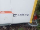 a white refrigerator sitting on the side of the road