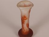 a glass vase with a design on it on a white surface