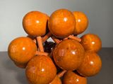 a wooden sculpture of a bunch of balls on a table