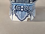 a small blue and white bowl with a design on it