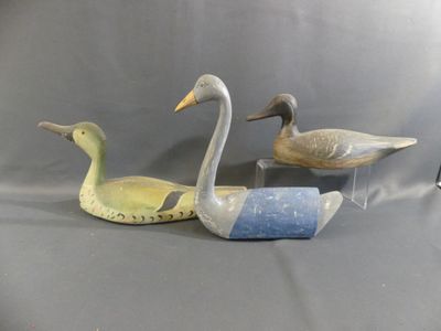 three ducks that are sitting next to each other on a table